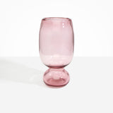 Dinosaur Designs Tall Glass Rockpool Vase in Pink — handblown transparent pink glass vase with rounded bulbous body and spherical pedestal base..