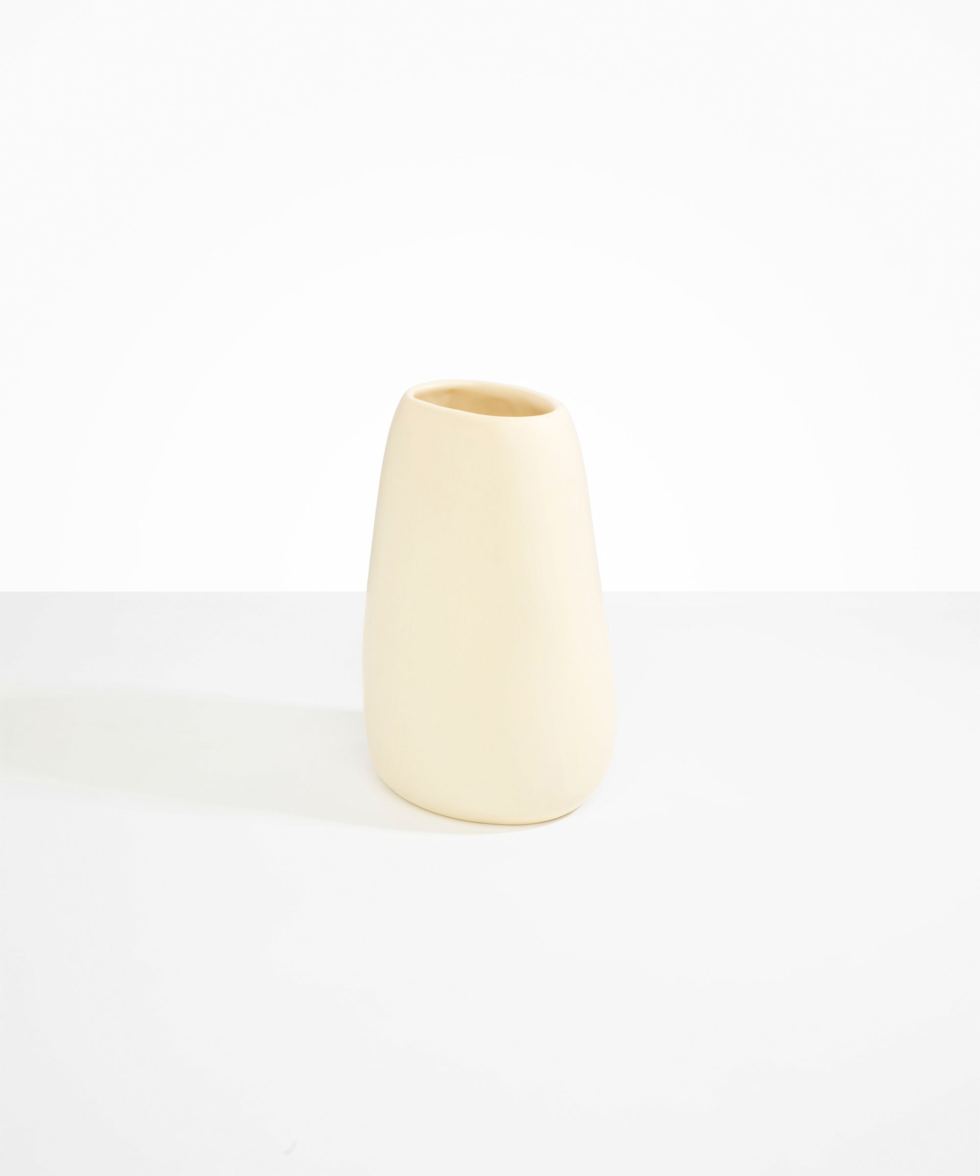 Dinosaur Designs Large Pebble Vase in Cream — handcrafted cream resin vase with smooth rounded pebble form and narrow opening
