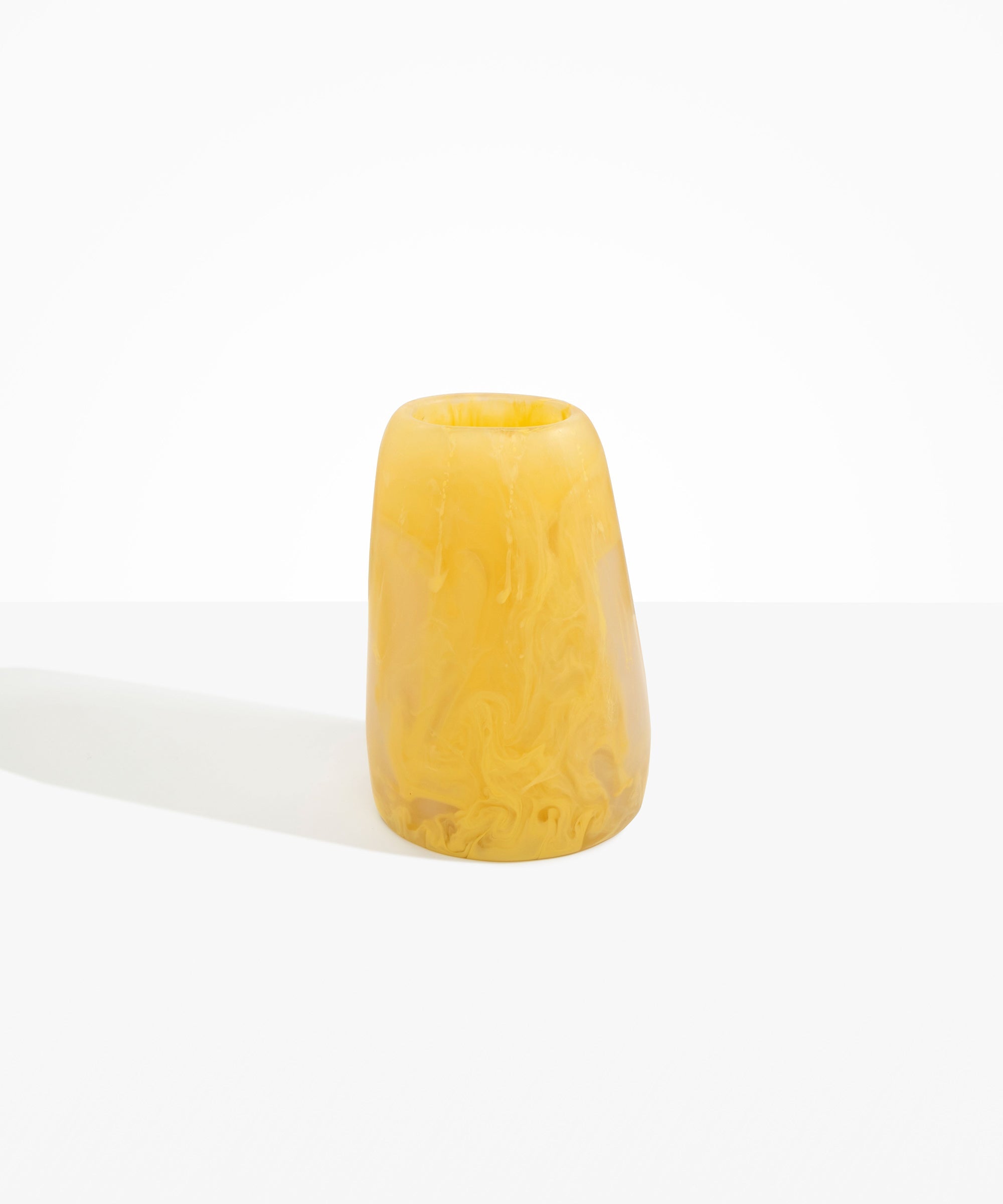 Dinosaur Designs Large Pebble Vase in Pollen — handcrafted marbled yellow and transparent resin vase with smooth rounded pebble form and narrow opening.