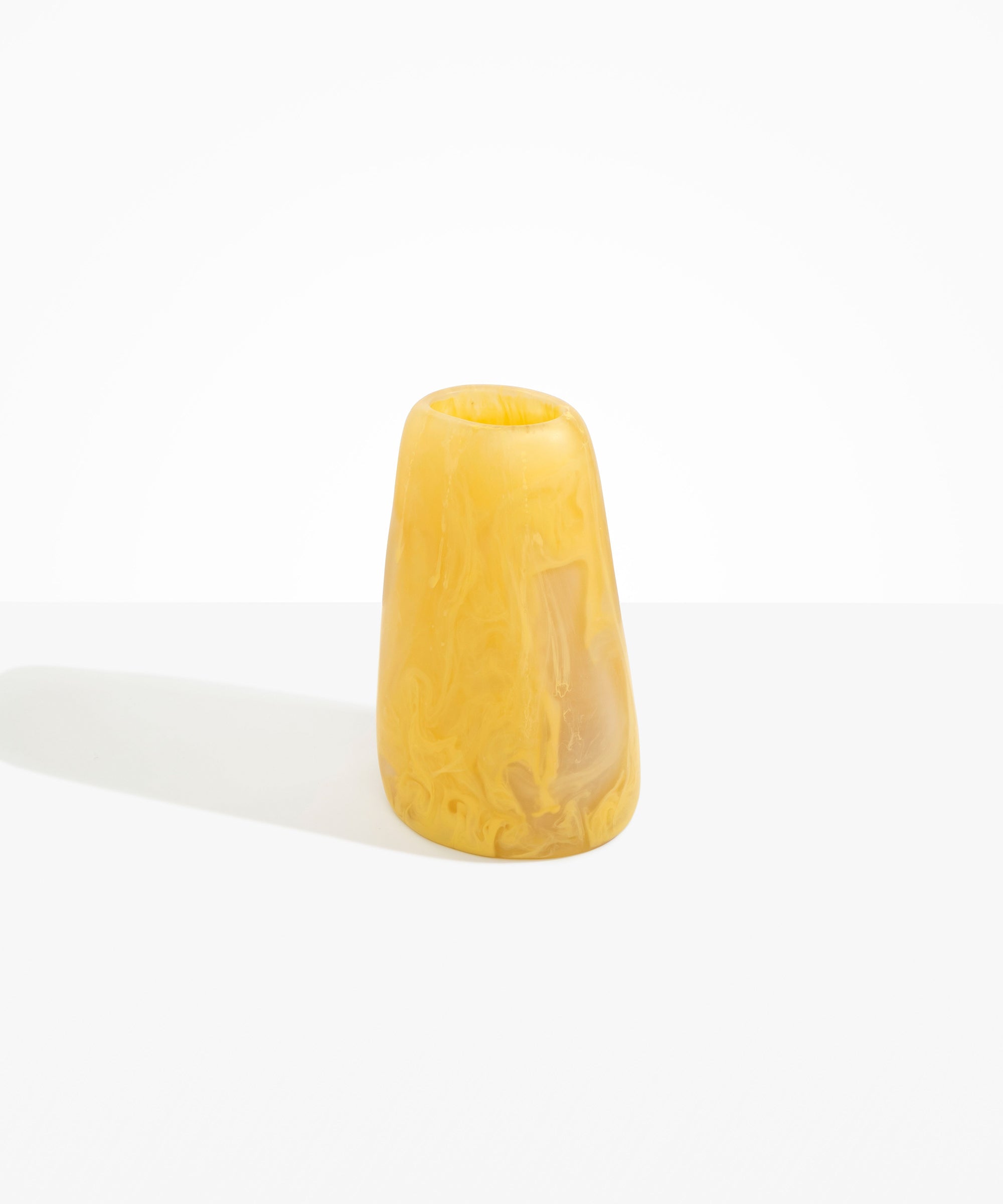 Dinosaur Designs Large Pebble Vase in Pollen — handcrafted marbled yellow and transparent resin vase with smooth rounded pebble form and narrow opening.