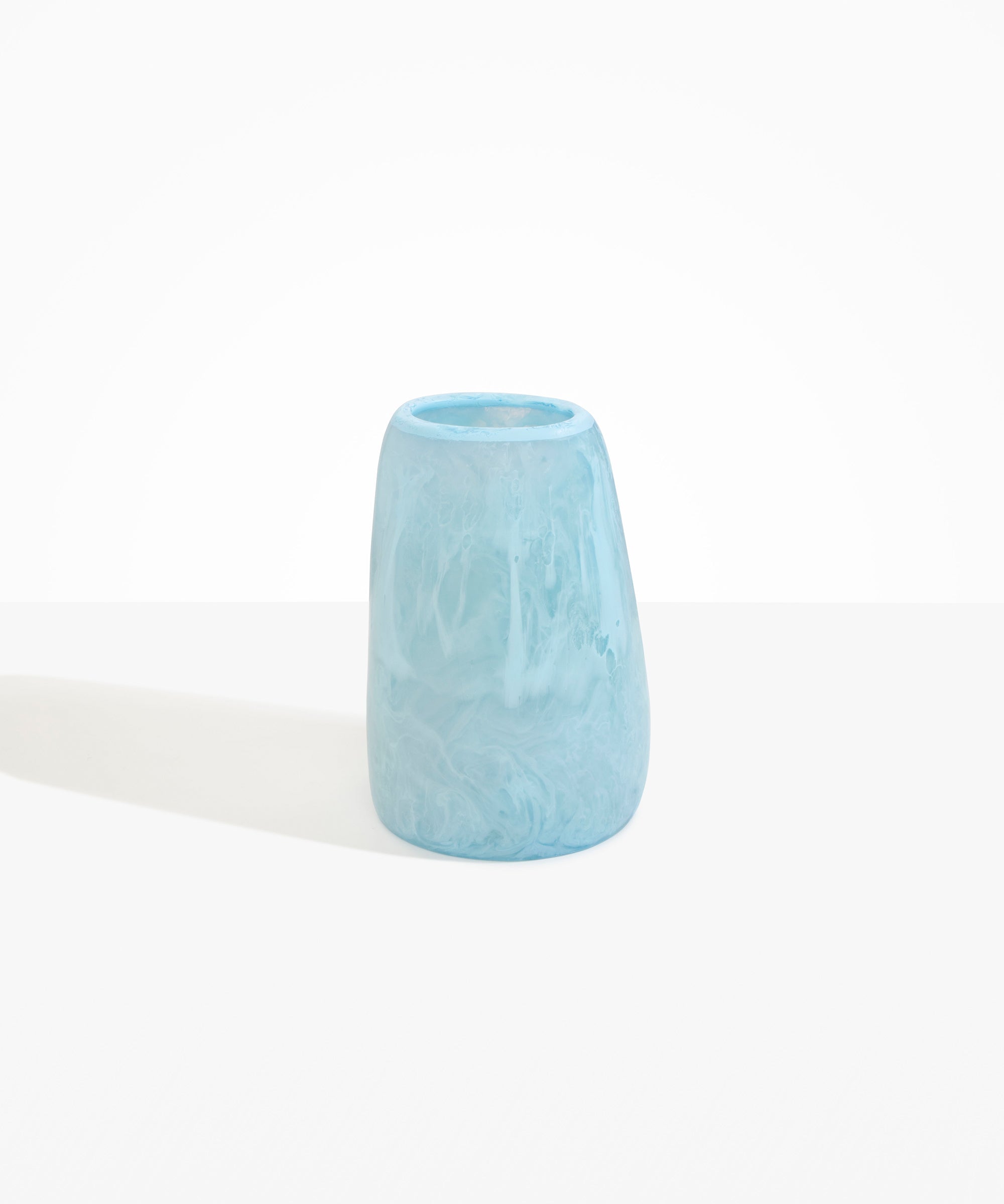 Dinosaur Designs Large Pebble Vase in Pool — handcrafted marbled blue and transparent resin vase with smooth rounded pebble form and narrow opening.