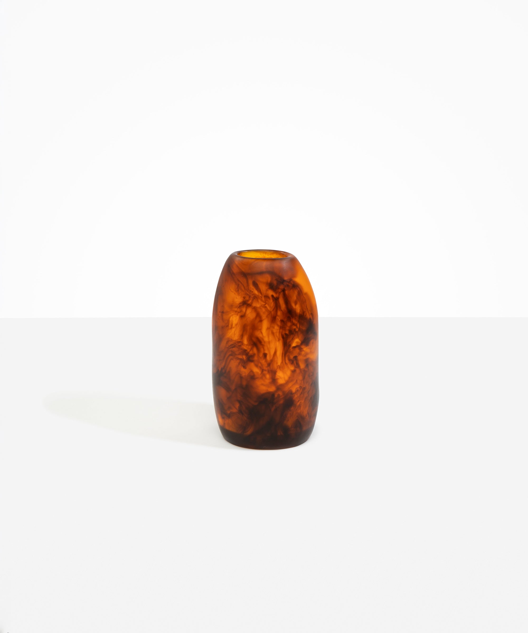 Dinosaur Designs Medium Pebble Vase in Tortoise — handcrafted marbled amber and black resin vase with smooth rounded pebble form and narrow opening
