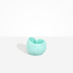 Dinosaur Designs Orchid Vase in Mint — handcrafted marbled mint blue resin vase with short rounded organic form and sculpted open petal-shaped rim