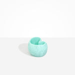 Dinosaur Designs Orchid Vase in Mint — handcrafted marbled mint blue resin vase with short rounded organic form and sculpted open petal-shaped rim