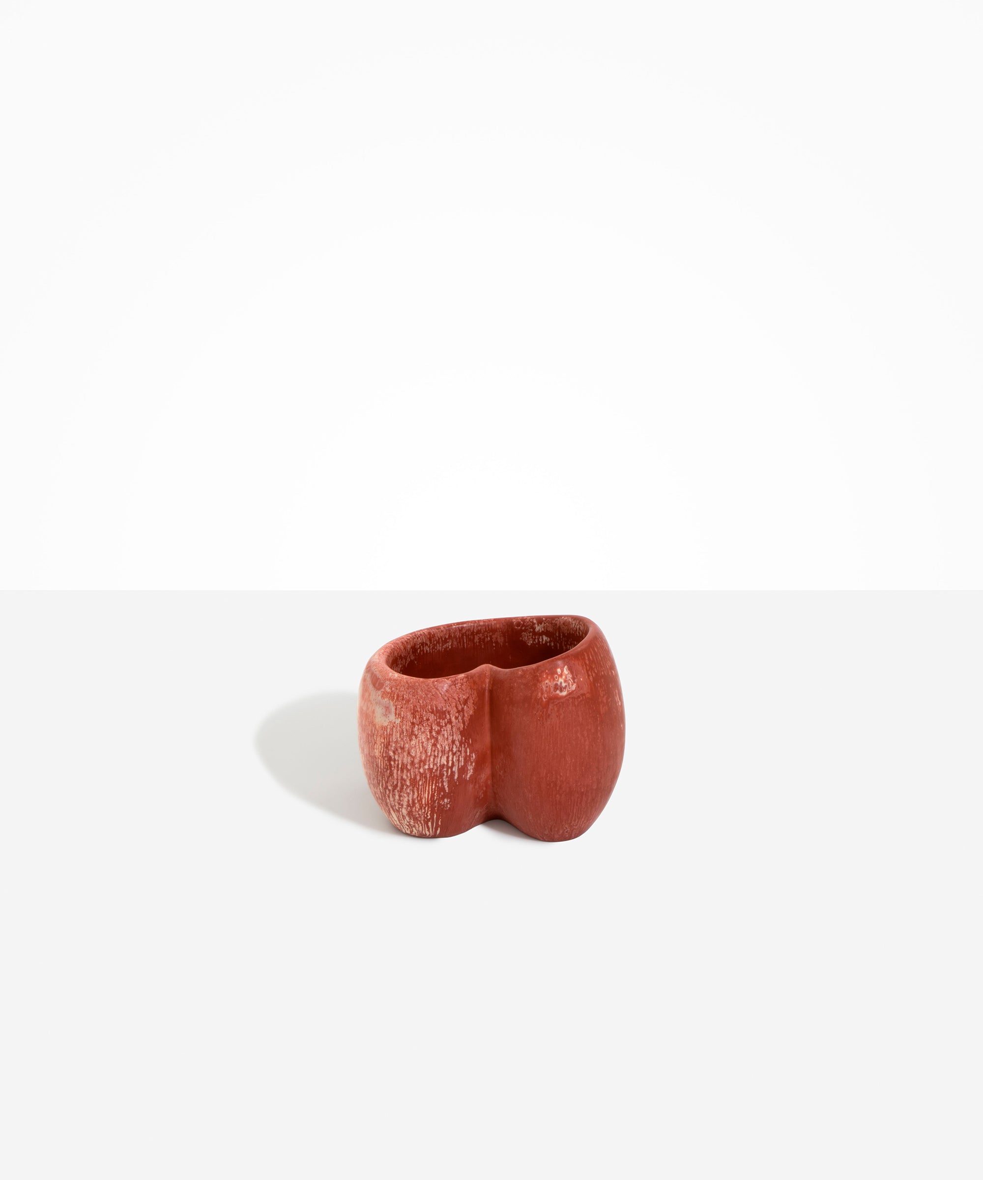 Dinosaur Designs Orchid Vase in Rust — handcrafted marbled terracotta red and cream resin vase with short rounded organic form and sculpted open petal-shaped rim