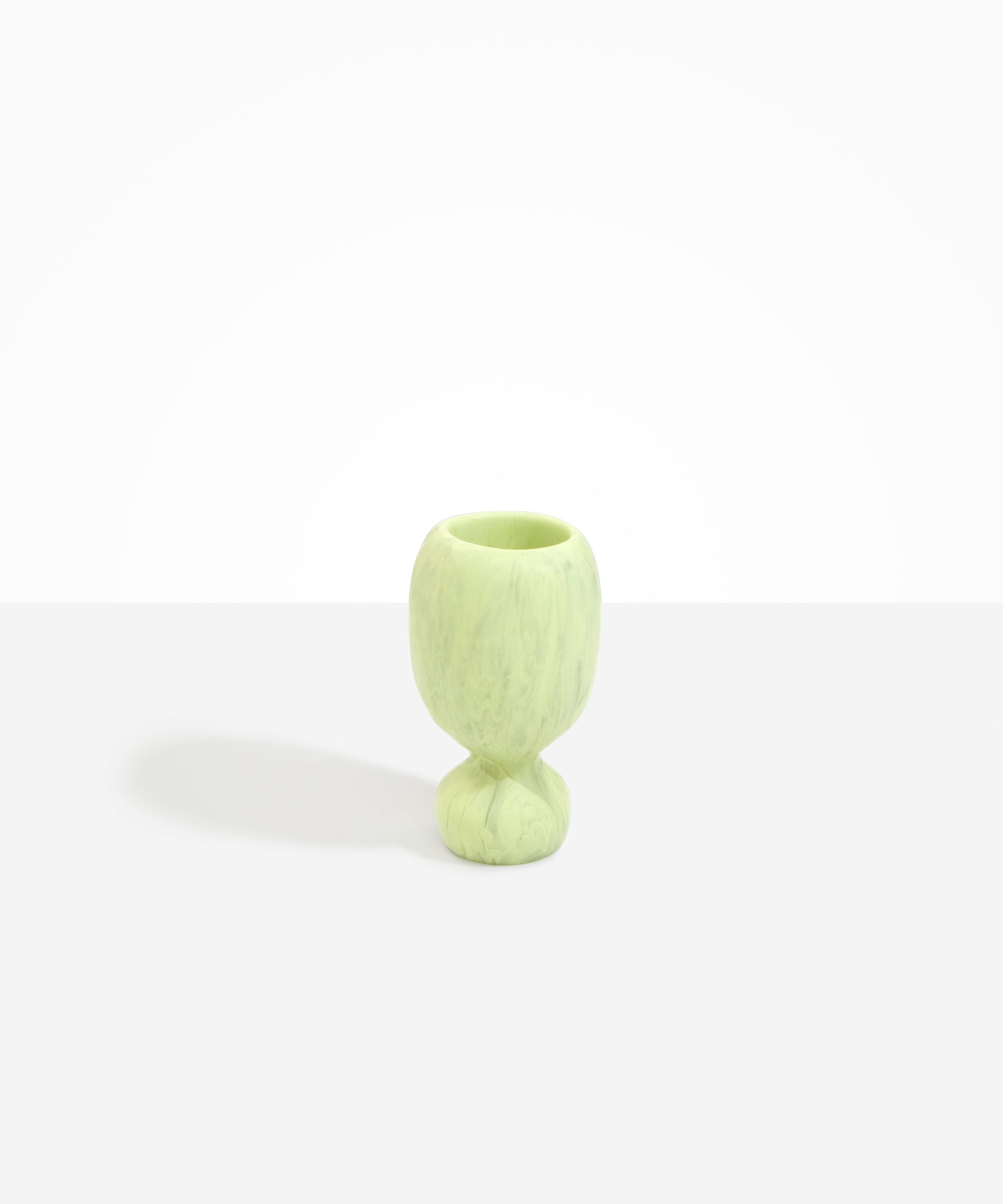 Dinosaur Designs Small Rockpool Vase in Pistachio — handcrafted marbled pastel green resin vase with rounded bulbous body and small spherical pedestal base
