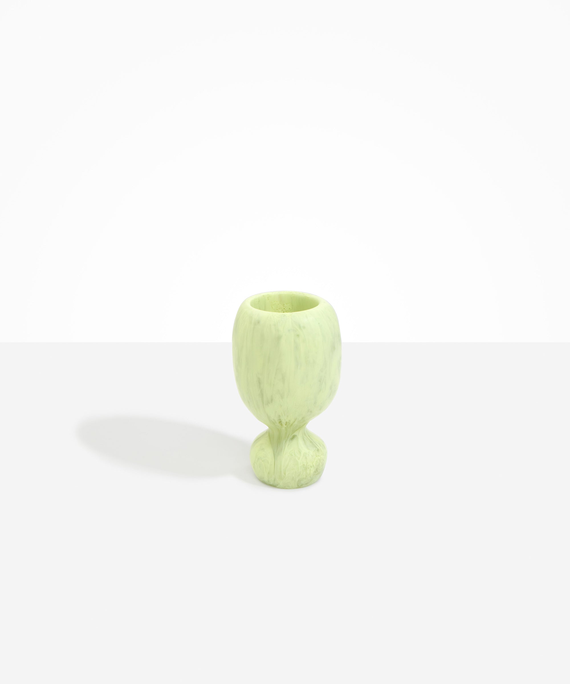 Dinosaur Designs Small Rockpool Vase in Pistachio — handcrafted marbled pastel green resin vase with rounded bulbous body and small spherical pedestal base