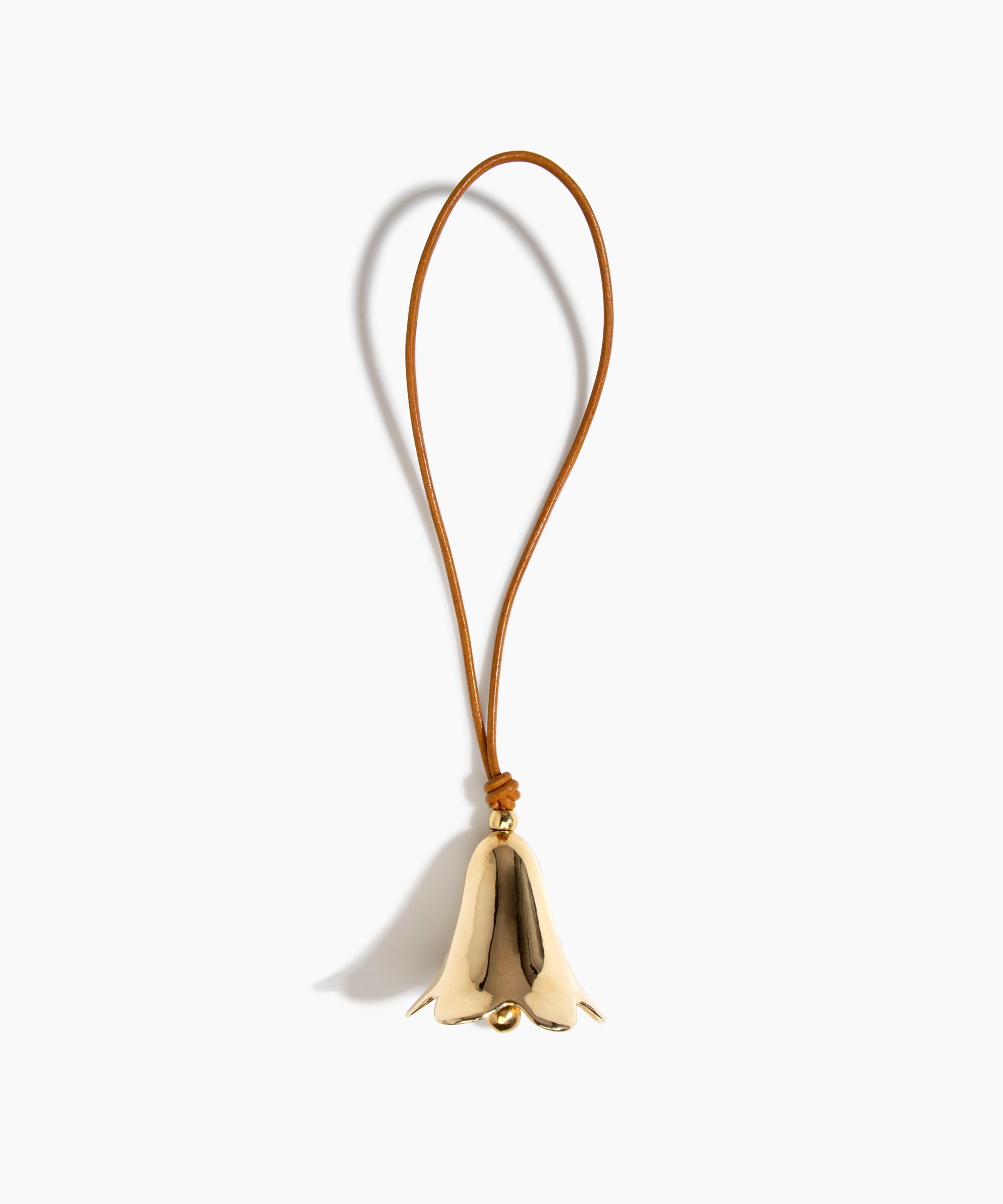 Dinosaur Designs Metal Flower Wind Chime in Brass — polished brass cast flower-shaped decorative wind chime with tan leather hanging loop