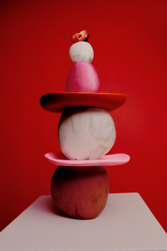 Various pink and red toned stacked vases and serving plates